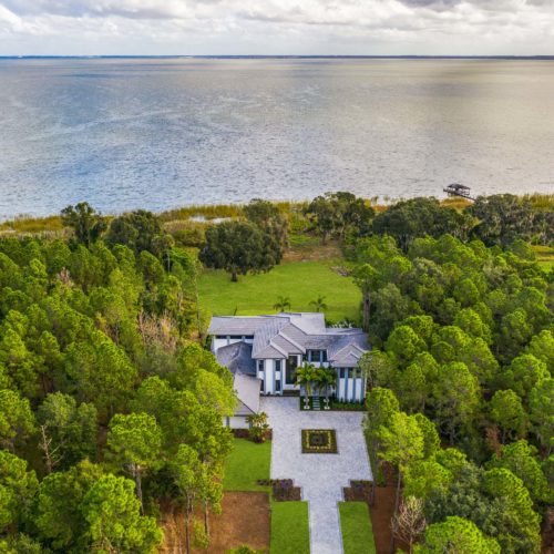 elevation shot of breathtaking custom luxury home by the water